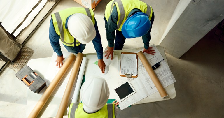 Construction crew on a job site with hard hats